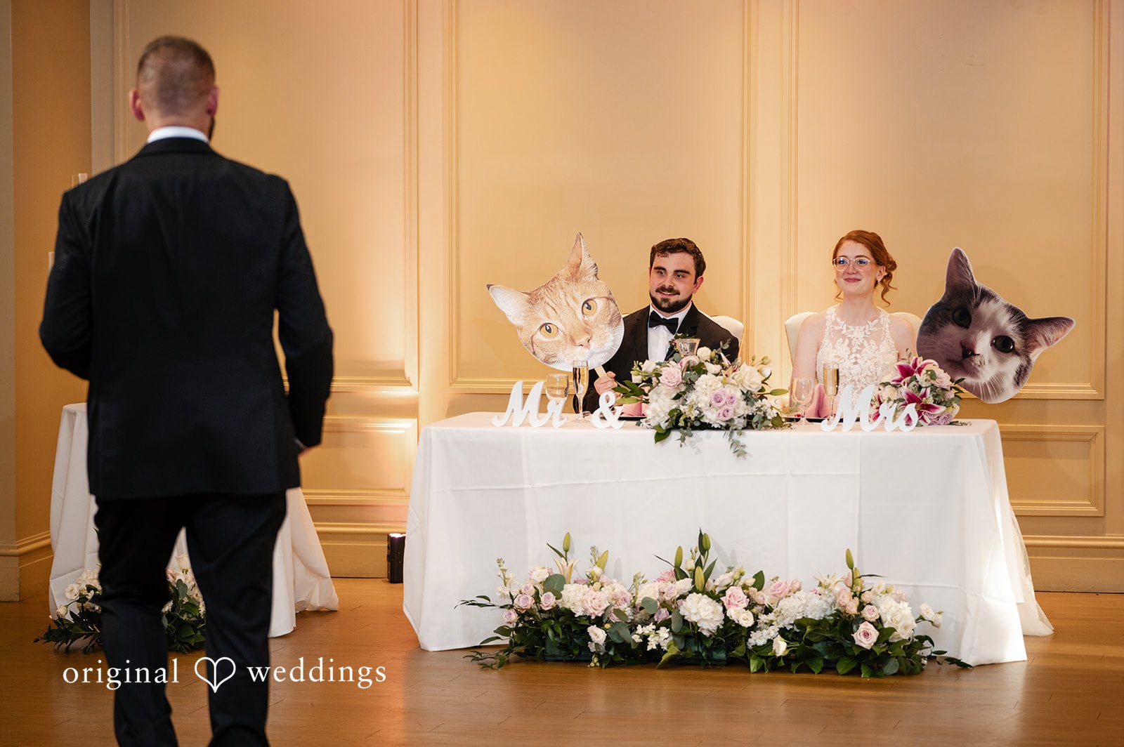 Aislyn + Alex Wedding couple seated at their decorated head table during reception speeches.
