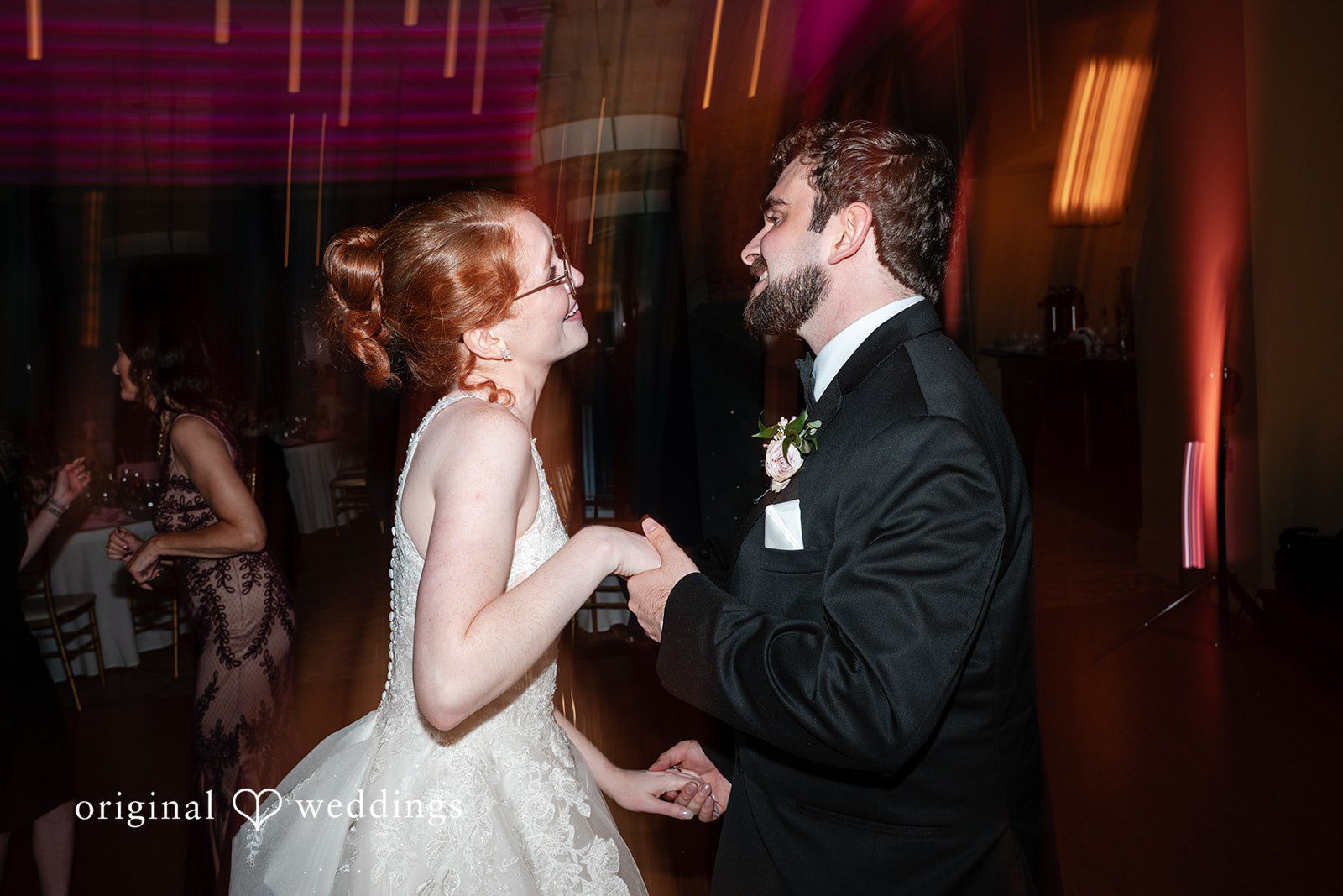 Aislyn + Alex Bride and groom smiling and laughing together while dancing at their reception.