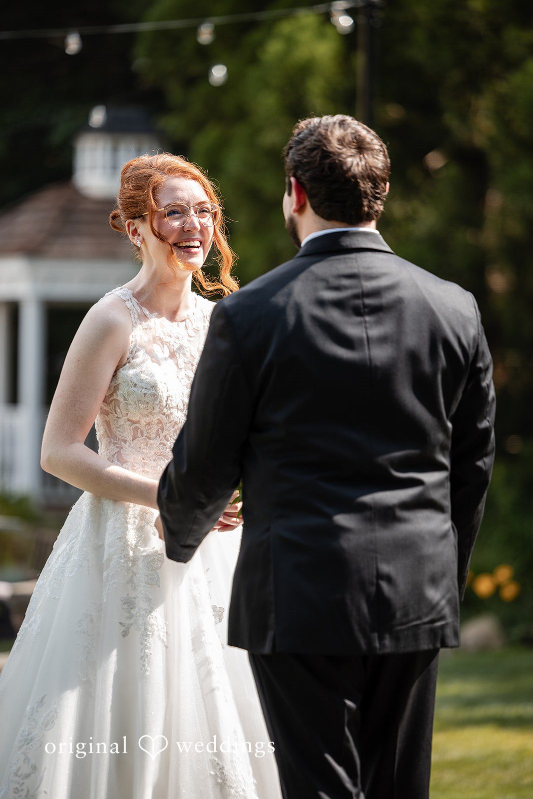 Aislyn + Alex Bride and groom holding hands and looking at each other from a distance.