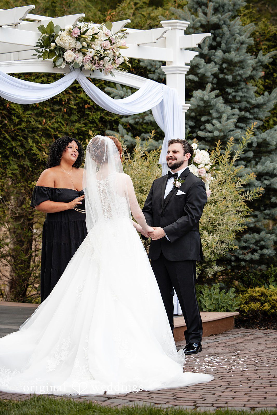 Aislyn + Alex Bride and groom standing together at the altar facing the marriage officiant.