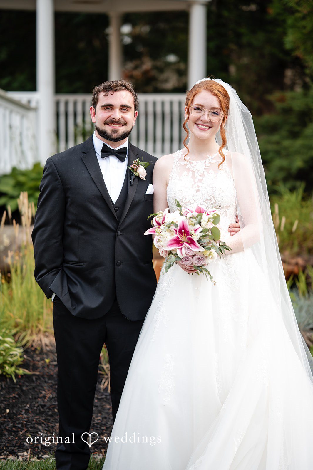 Aislyn + Alex Bride and groom standing close together and smiling for a portrait.
