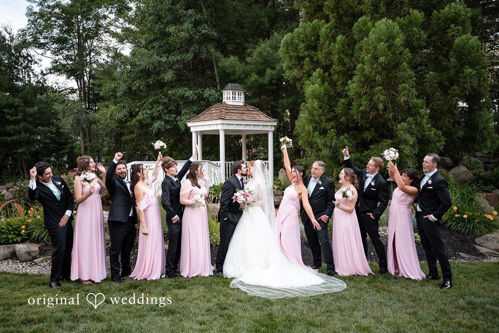 Aislyn + Alex Bride, groom, and bridesmaids standing together raising their glasses for a toast.