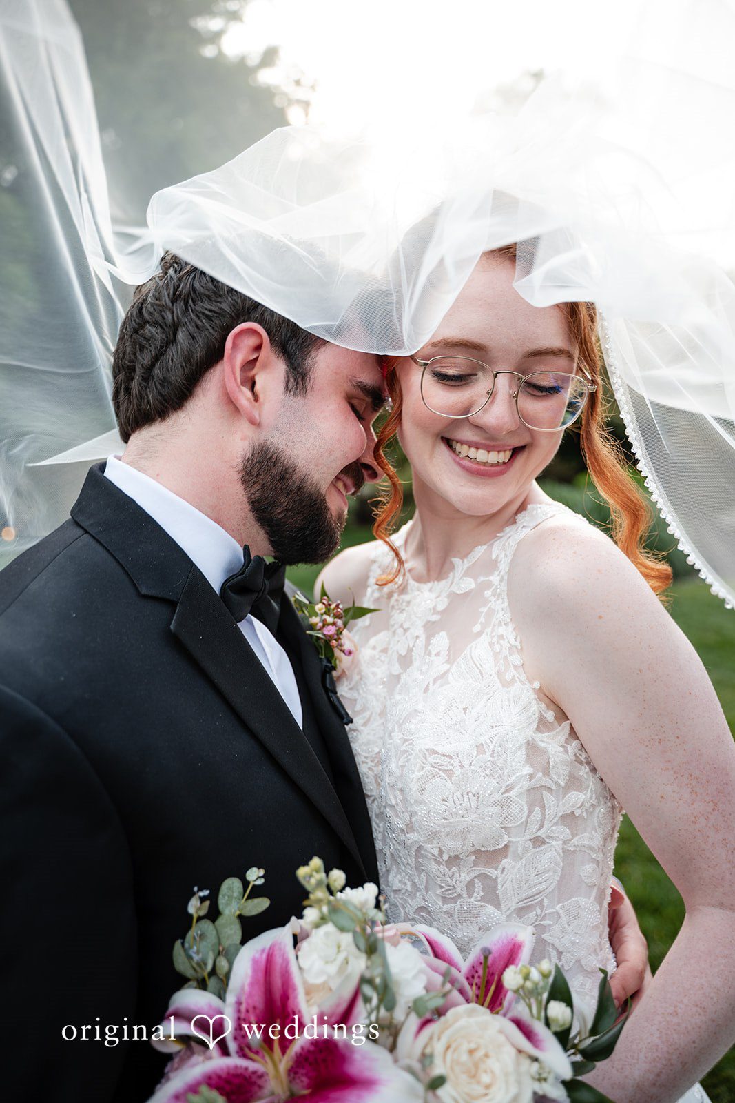 Aislyn + Alex Close-up portrait of the groom whispering to the smiling bride under her veil.