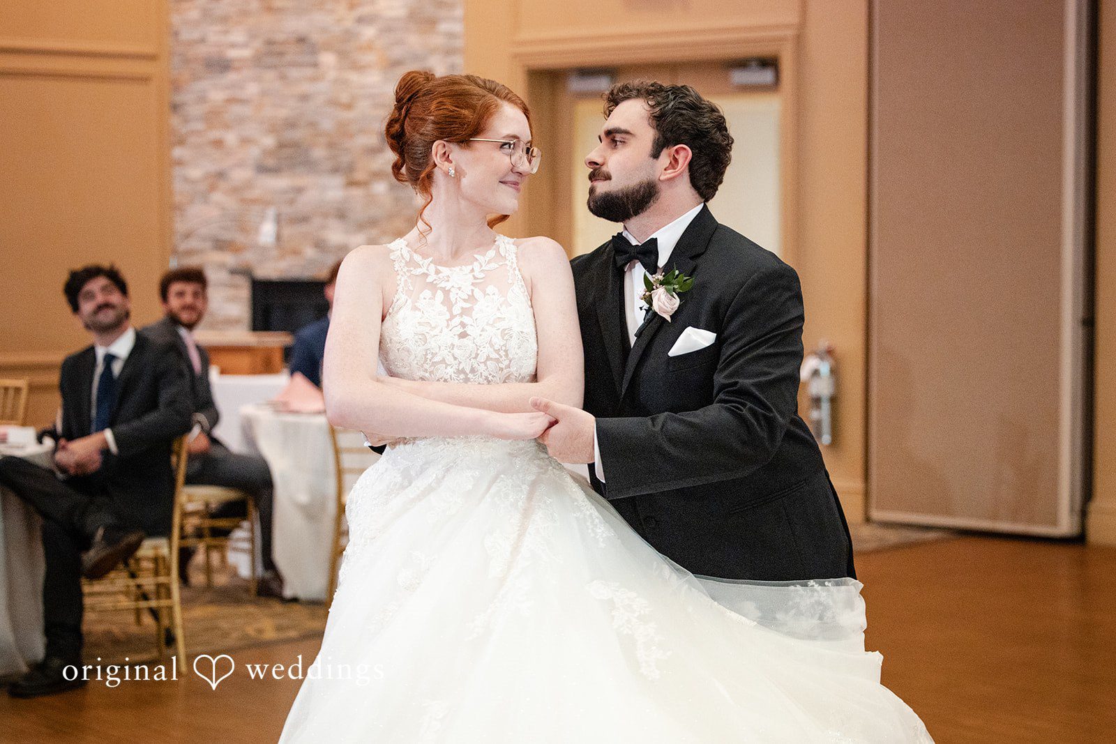 Aislyn + Alex Bride and groom performing their first dance surrounded by their wedding party.