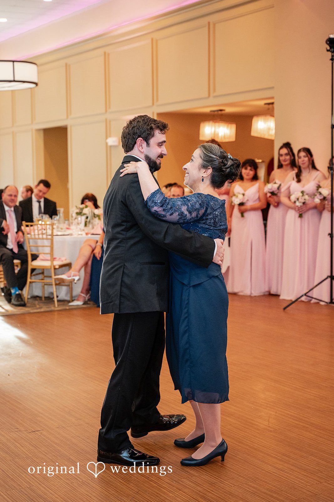 Aislyn + Alex Groom sharing a dance with an older woman in a blue dress.