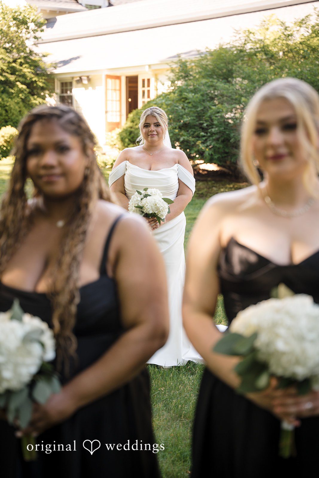 Ashley + Jonathan Two bridesmaids smiling and posing together closely on a wedding day.