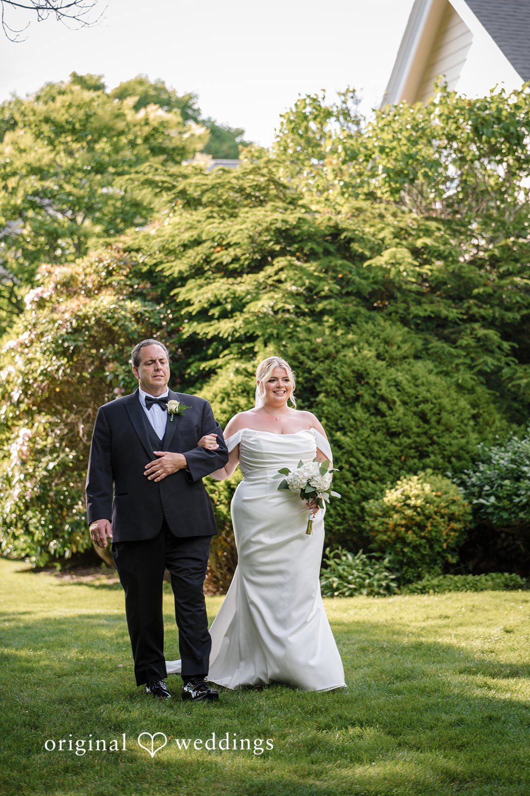 Ashley + Jonathan A bride and man walking down a grassy aisle during a wedding ceremony.