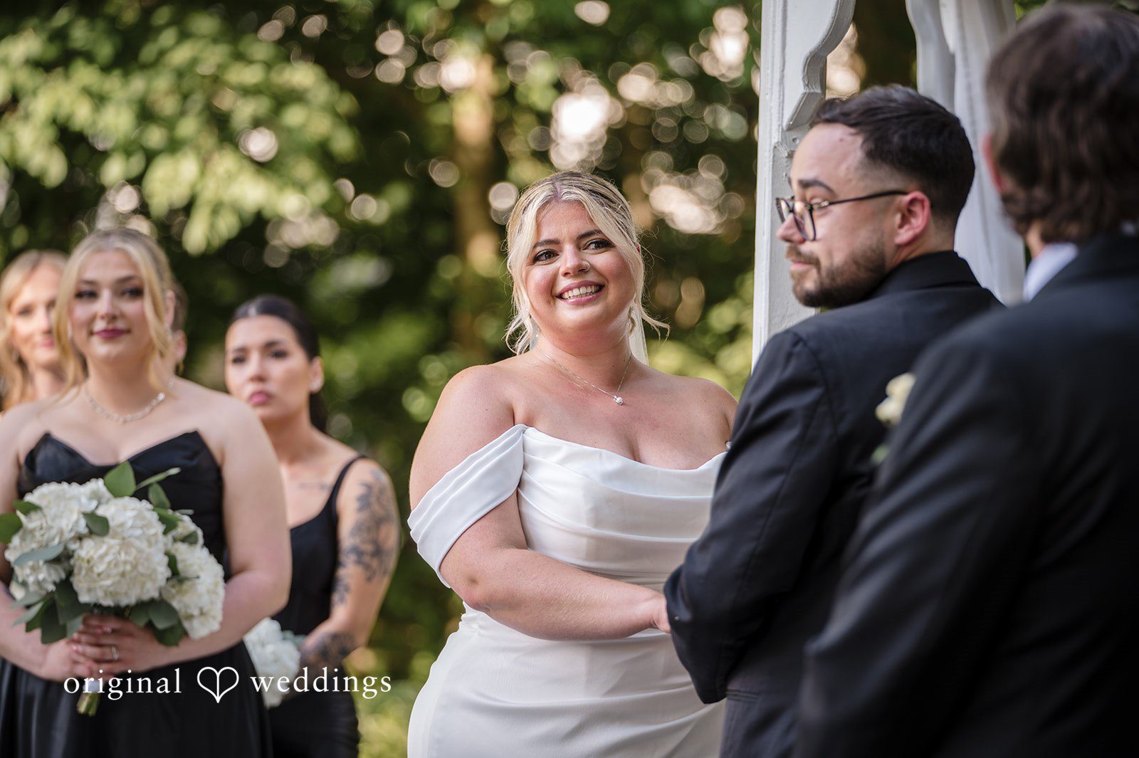 Ashley + Jonathan Close-up of a smiling bride and groom looking at each other.