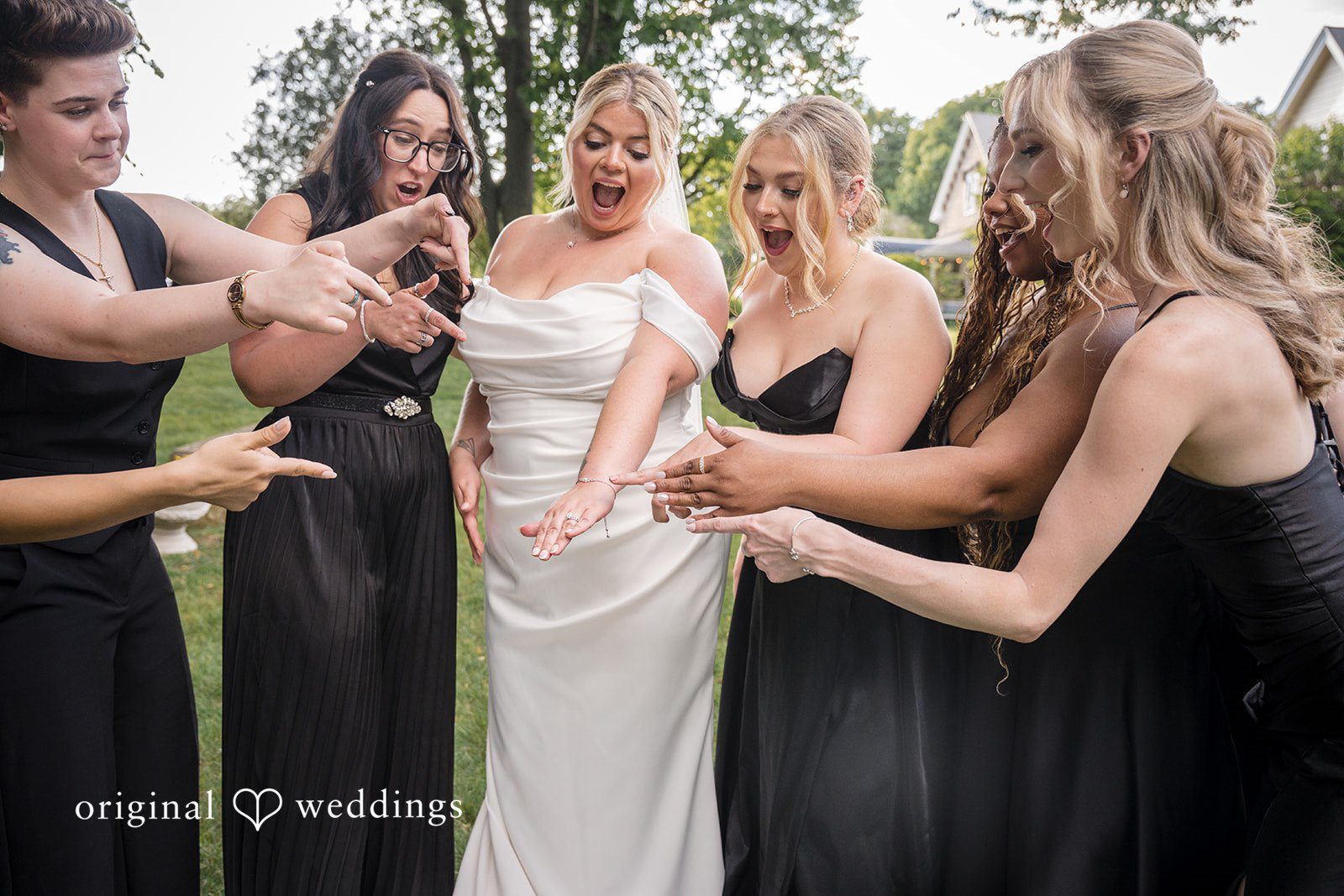 Ashley + Jonathan Bridesmaids in black dresses surrounding and celebrating with the bride.