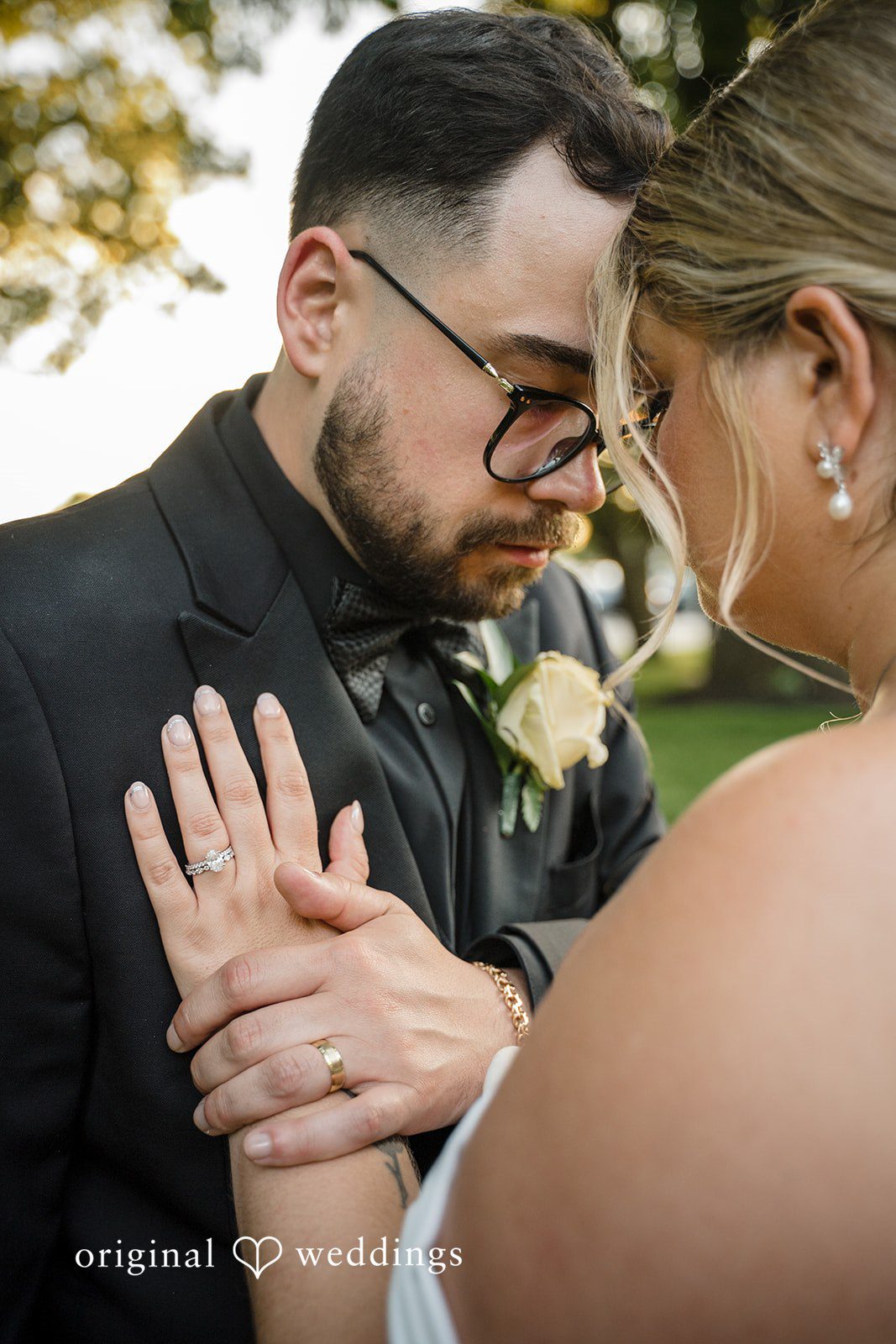 Ashley + Jonathan Close-up of a groom gently holding his bride's hand at Nahant Country Club.