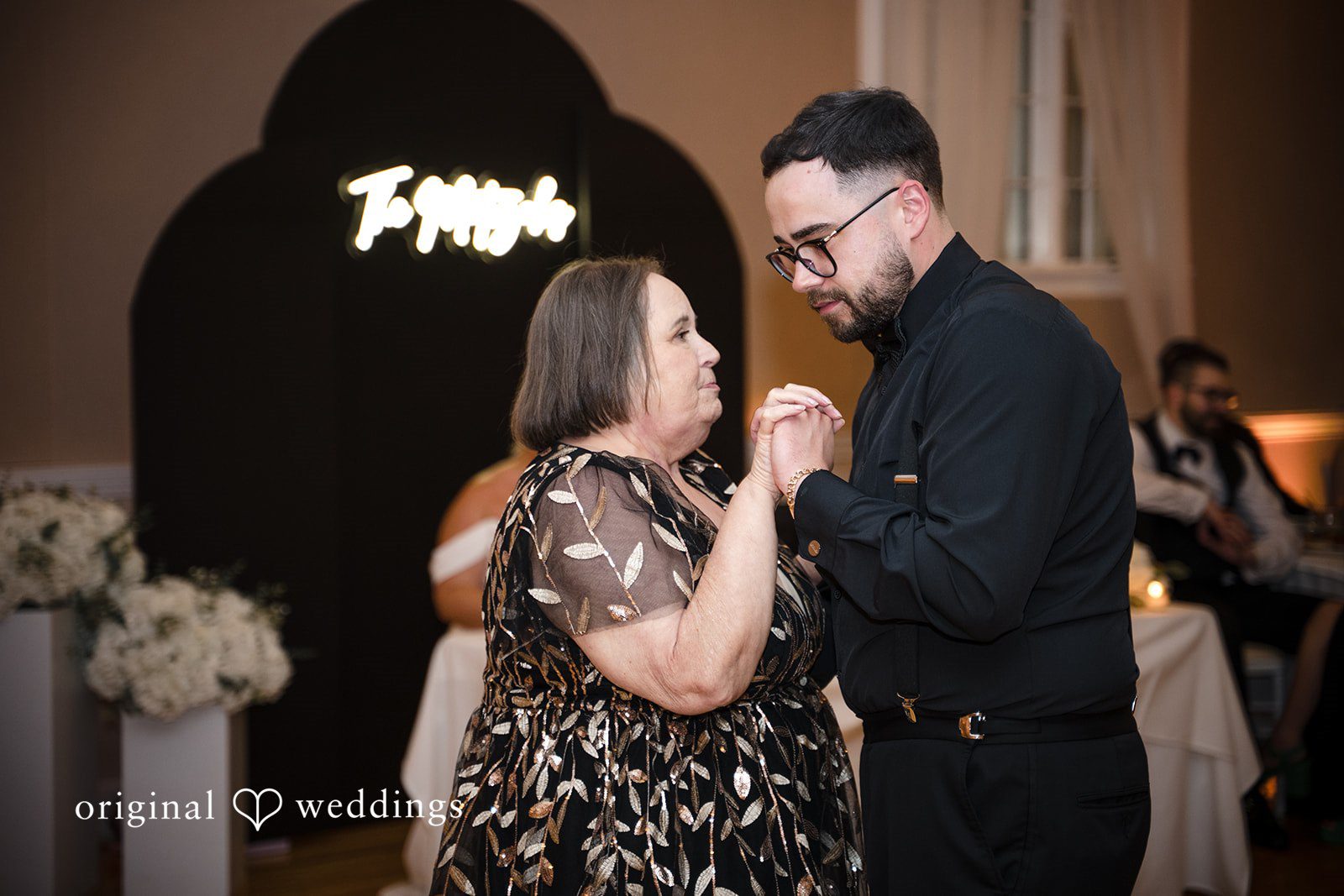 Ashley + Jonathan A groom sharing a sweet dance with an older female at the reception.