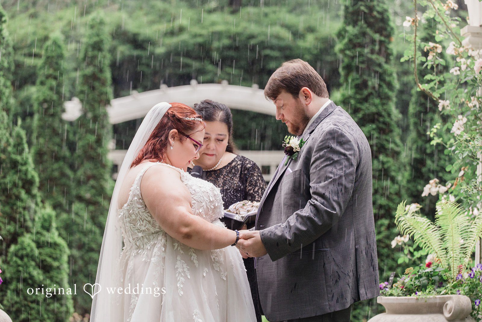 Grace + Nicholas A bride and groom looking down at their hands during the ceremony.