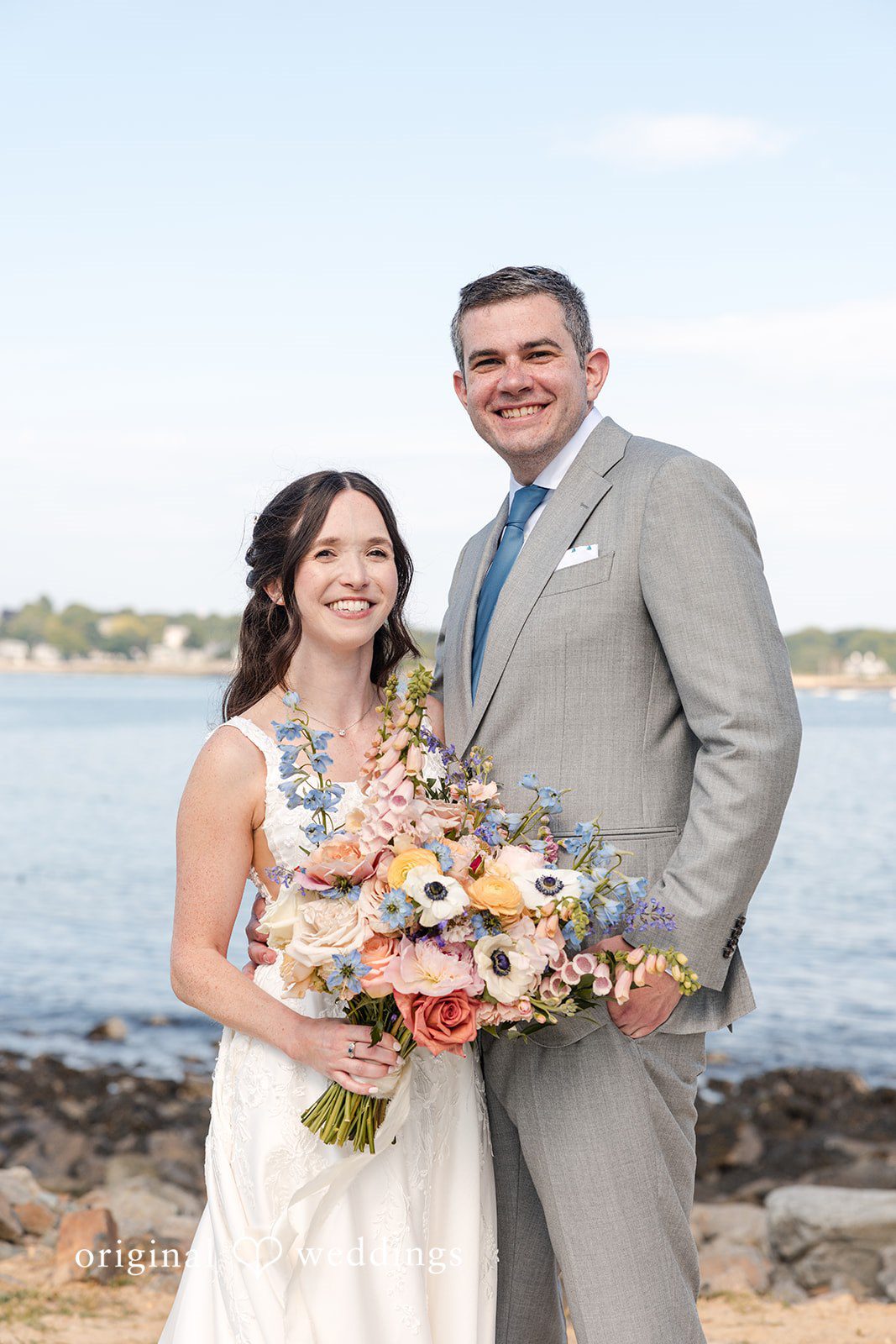 Kerri + David Newlyweds posing along the scenic coastline at Oceanview of Nahant.