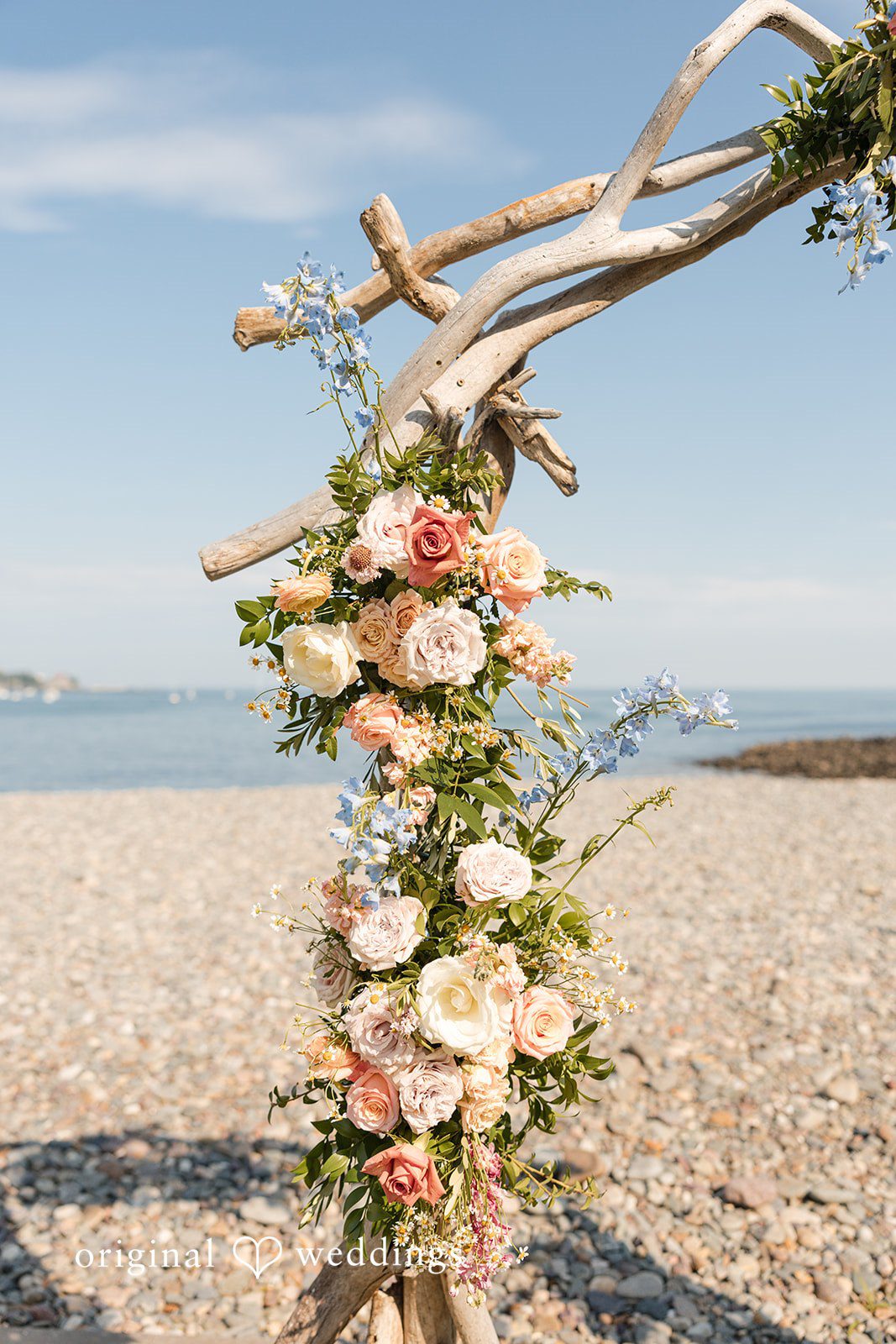 Kerri + David Close-up of a driftwood floral wedding arch at Oceanview of Nahant