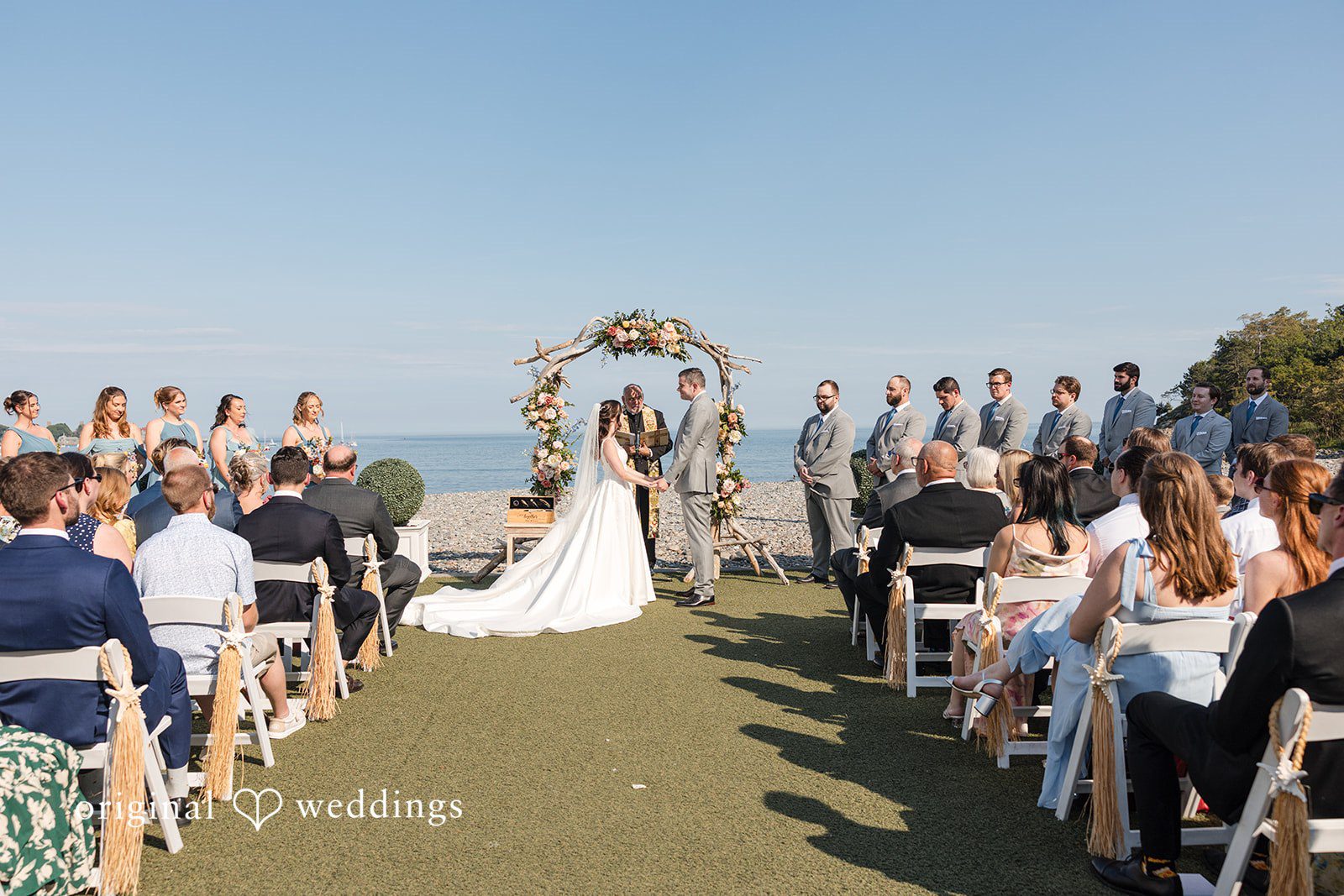 Kerri + David Bride and groom holding hands during their wedding ceremony