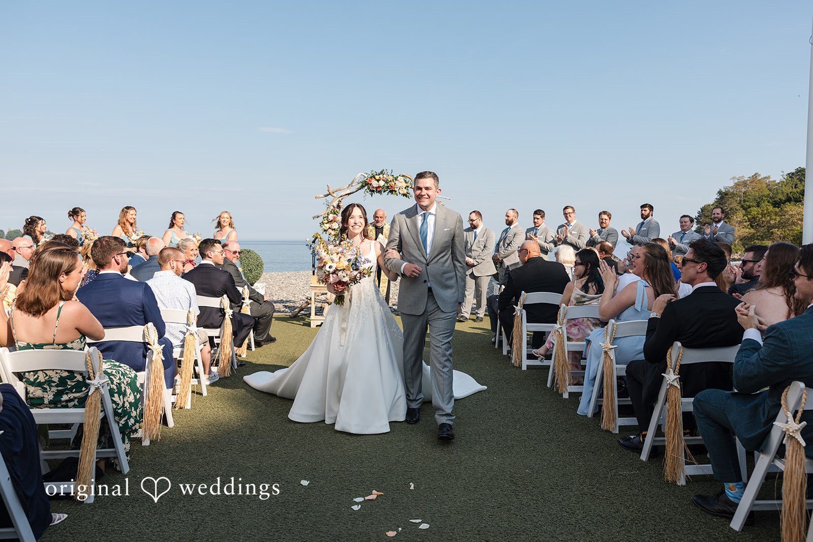 Kerri + David Bride and groom walking together after ceremony at Oceanview of Nahant captured by Boston Wedding Photographers from Original Weddings