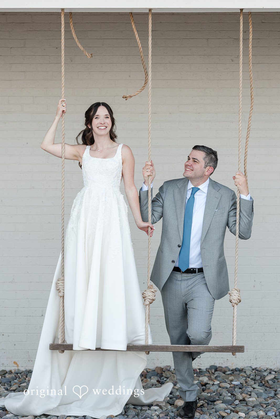 Kerri + David Newlyweds sharing smiles on a rustic swing at Oceanview of Nahant