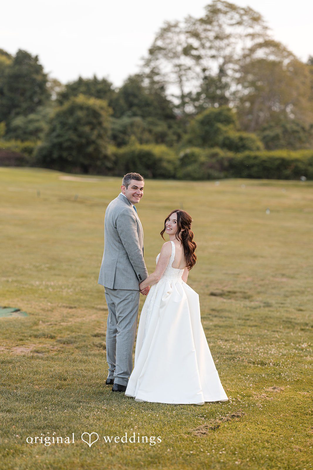 Kerri + David Elegant newlyweds standing on the lawn at Oceanview of Nahant during sunset.