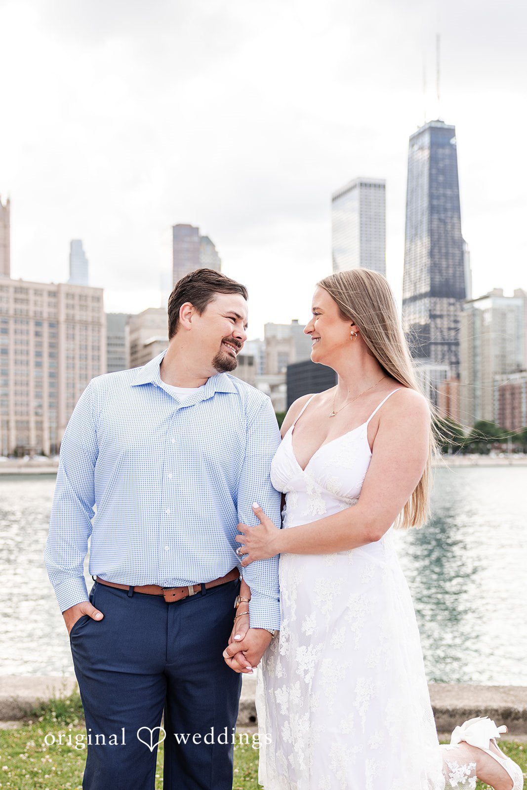 A romantic portrait of the couple by the waterfront