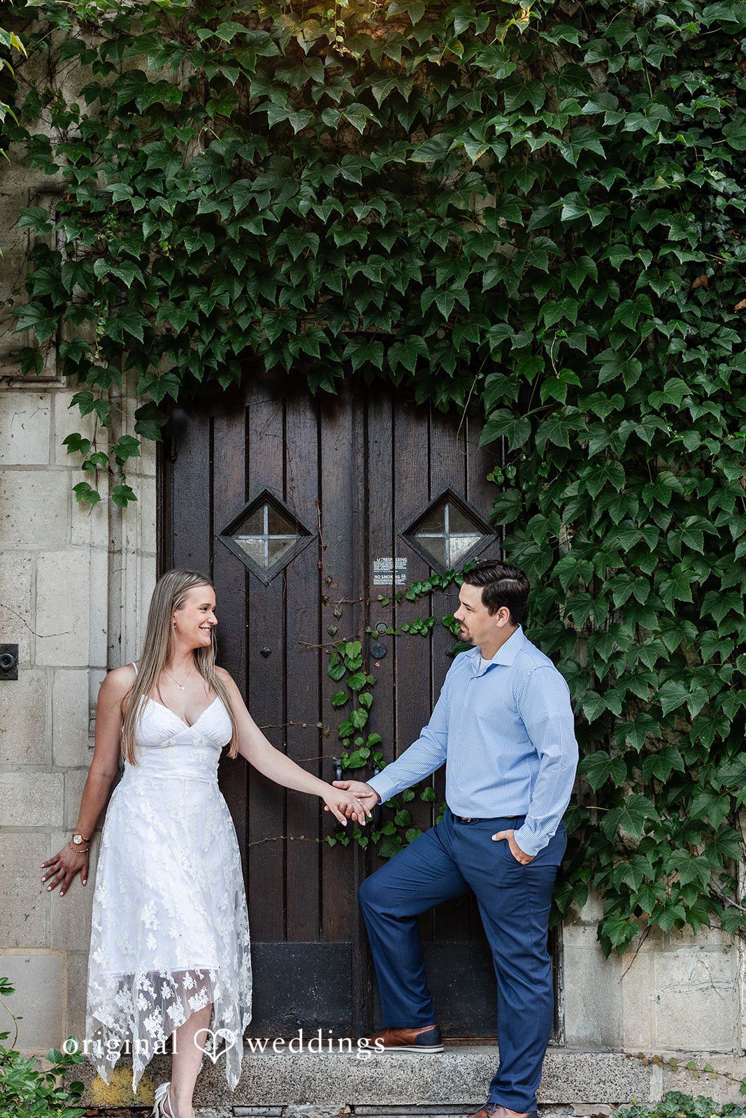 A stylish portrait of the couple framed by the greenery at Olive Park