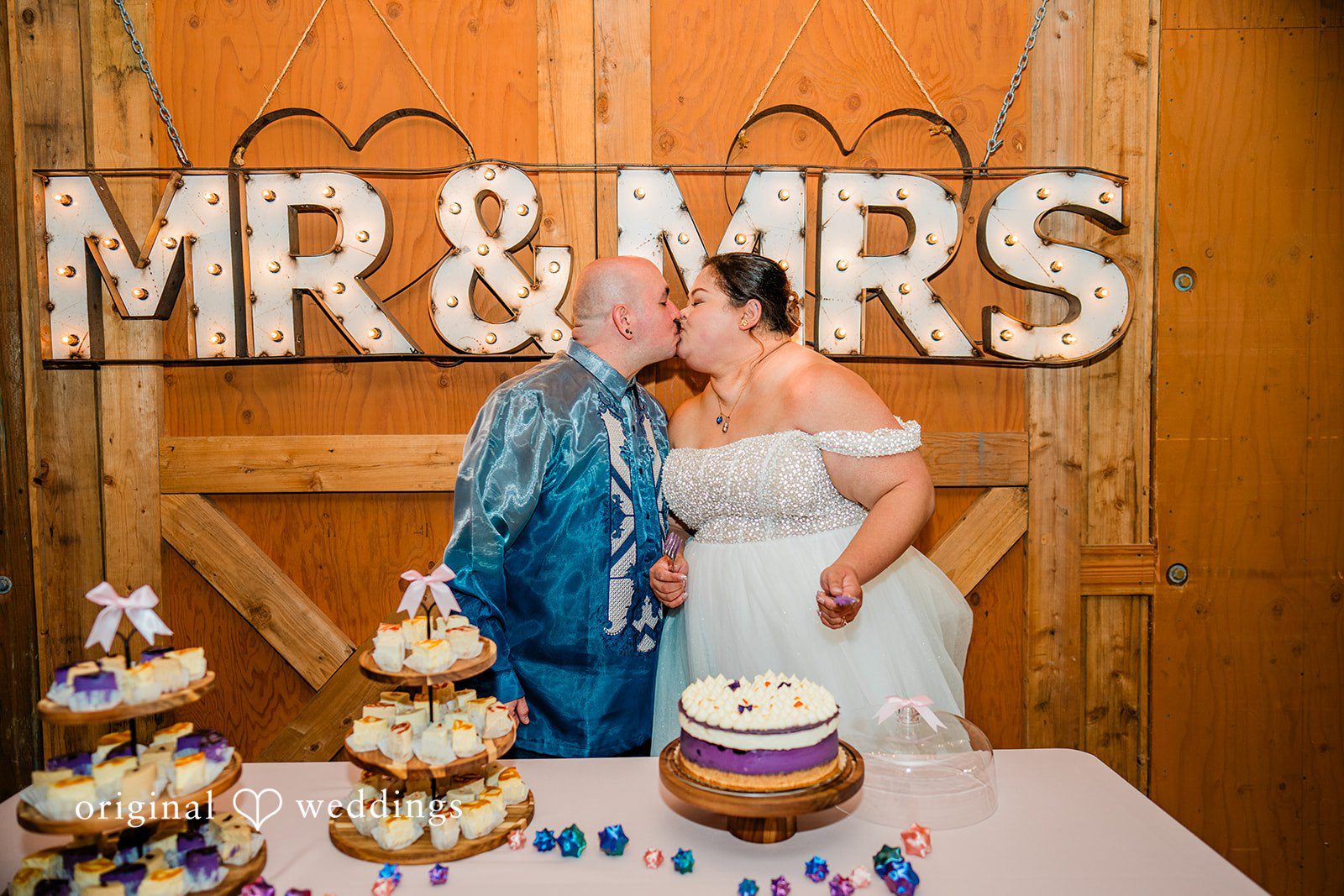 Tiffany Hazel + Ryan The couple takes a romantic kiss to seal the cake cutting