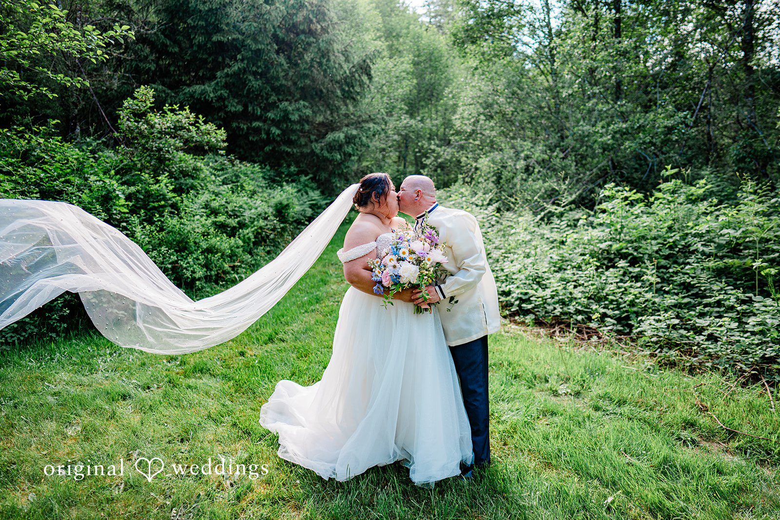 Tiffany Hazel + Ryan Our Seattle wedding photographers captured the moment the couple shared a kiss in the garden