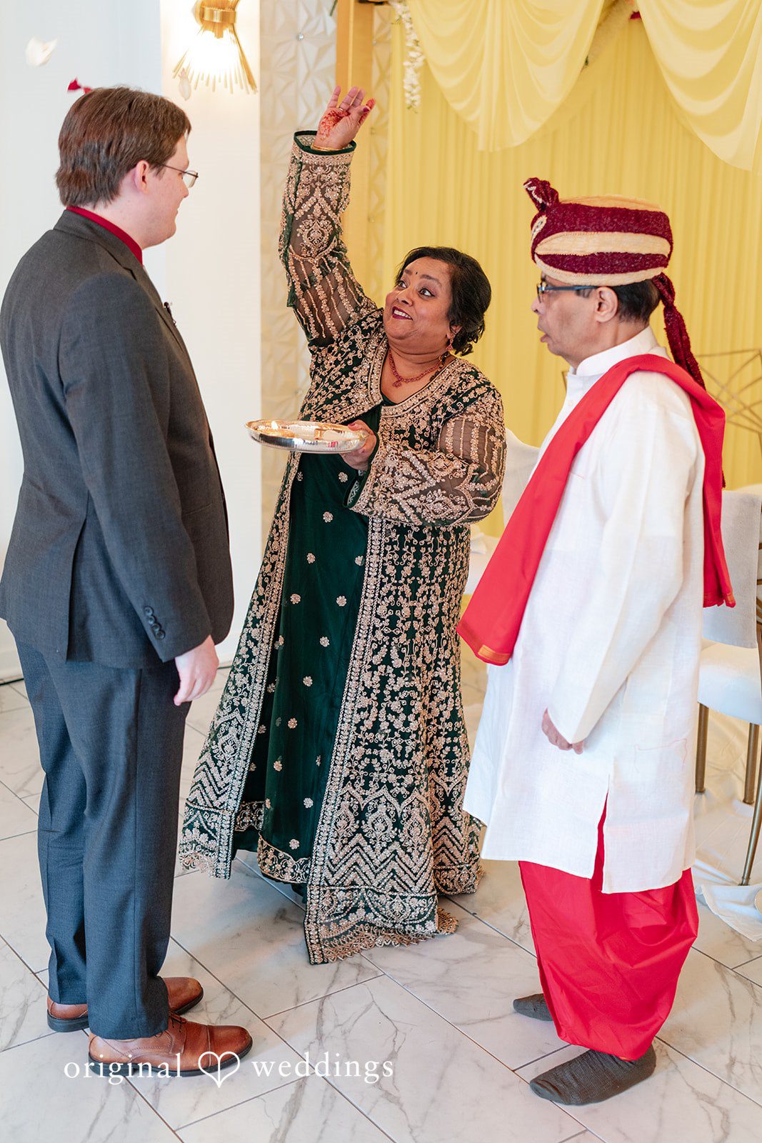 Anthony + Simi Wedding guests or family members participating in a joyful ceremony ritual.