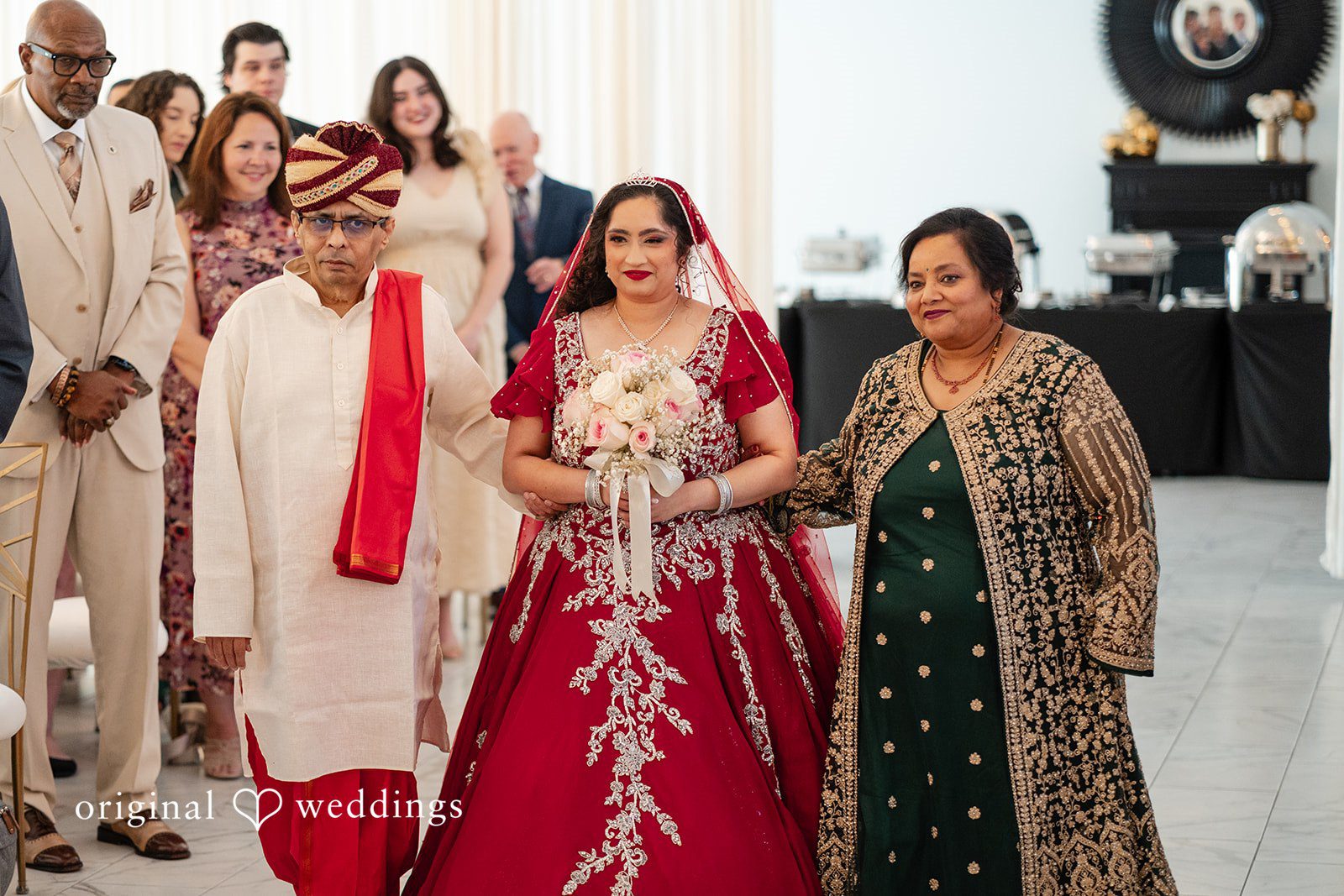 Anthony + Simi A bride walking down the aisle with man and women at Revelry 675.