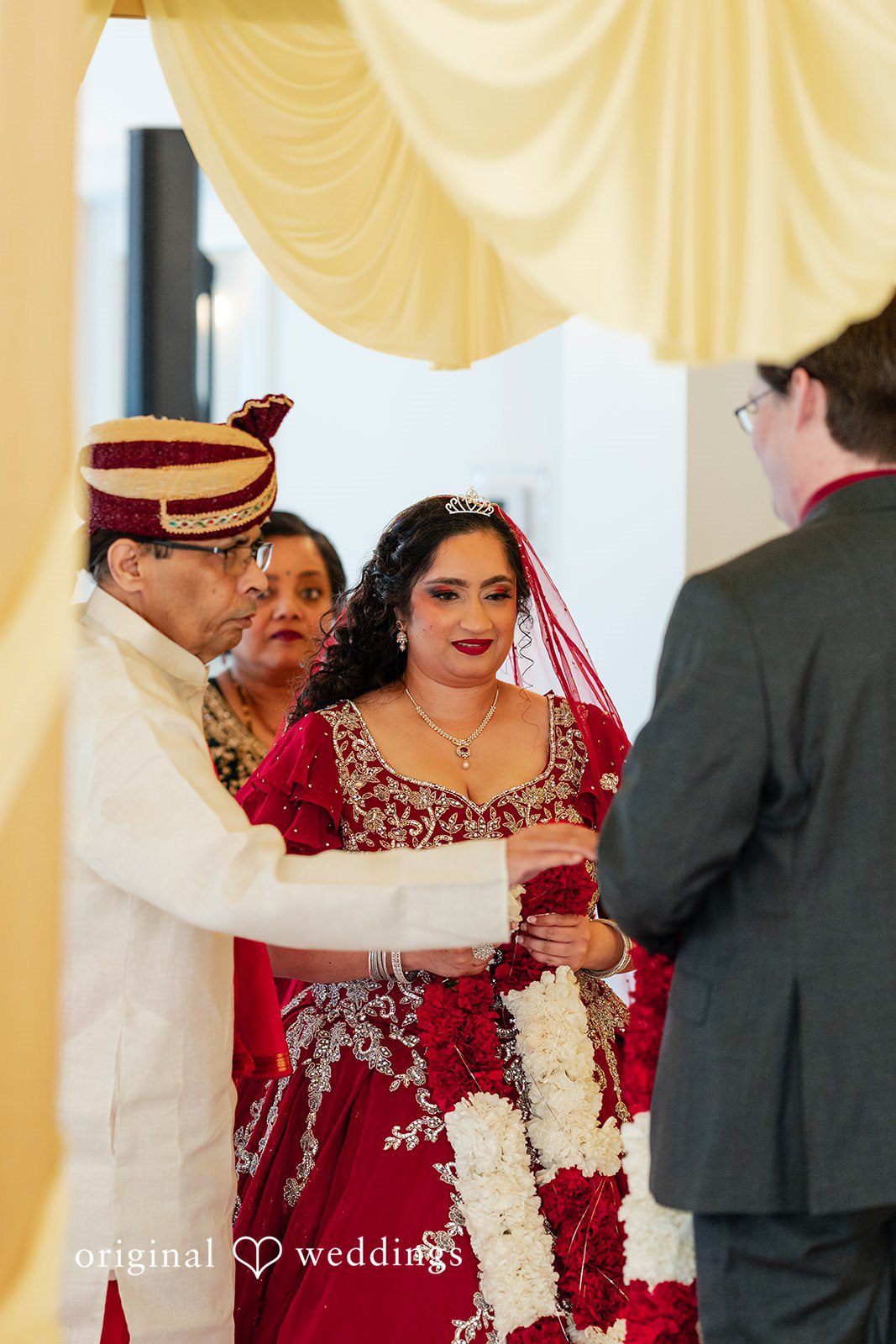 Anthony + Simi A groom facing his bride during an exchange of vows at the ceremony.