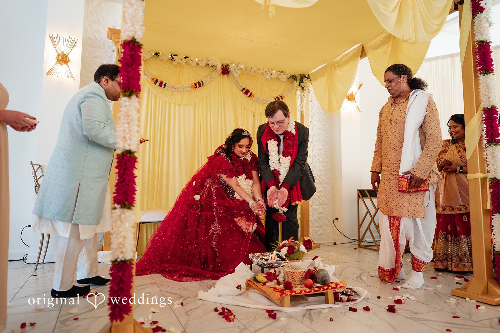 Anthony + Simi A bride and groom together on a stage during their ceremony.