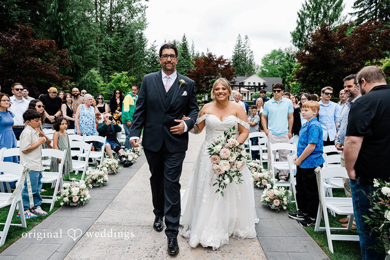 AlyssaMay + Benjamin Bride walking down the aisle arms in arms with someone at Rock Creek Gardens