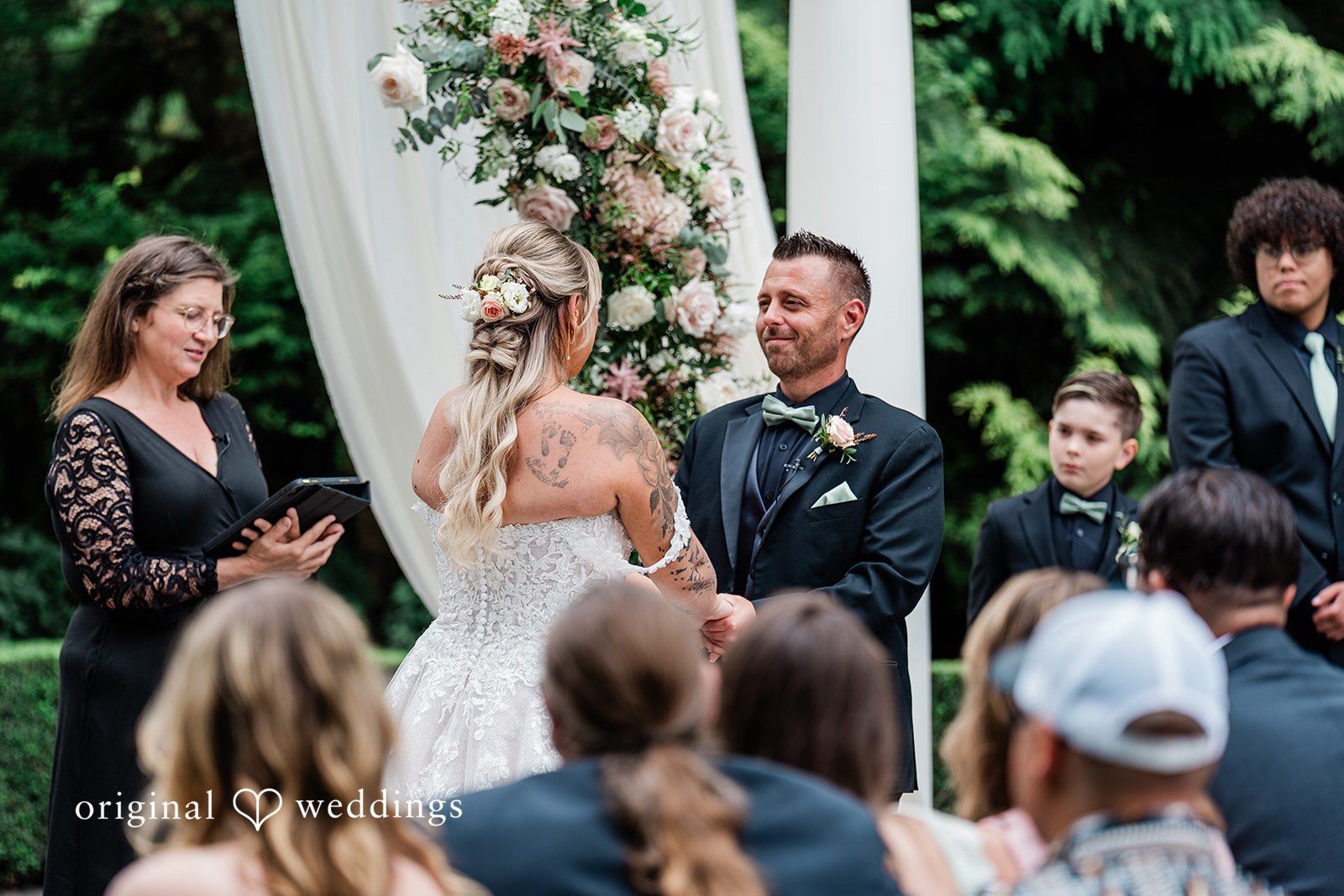 AlyssaMay + Benjamin Bride and groom looking at each other while holding hands at Rock Creek Gardens