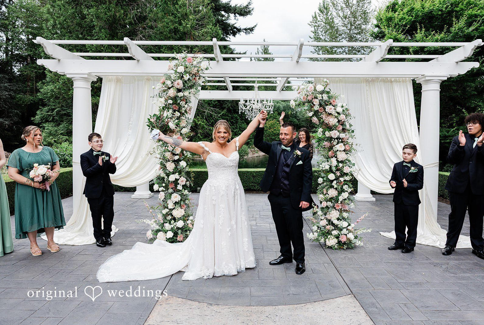 Bride and groom expressing their joy after wedding ceremony at Rock Creek Gardens captured by Seattle wedding photographers from Original Weddings
