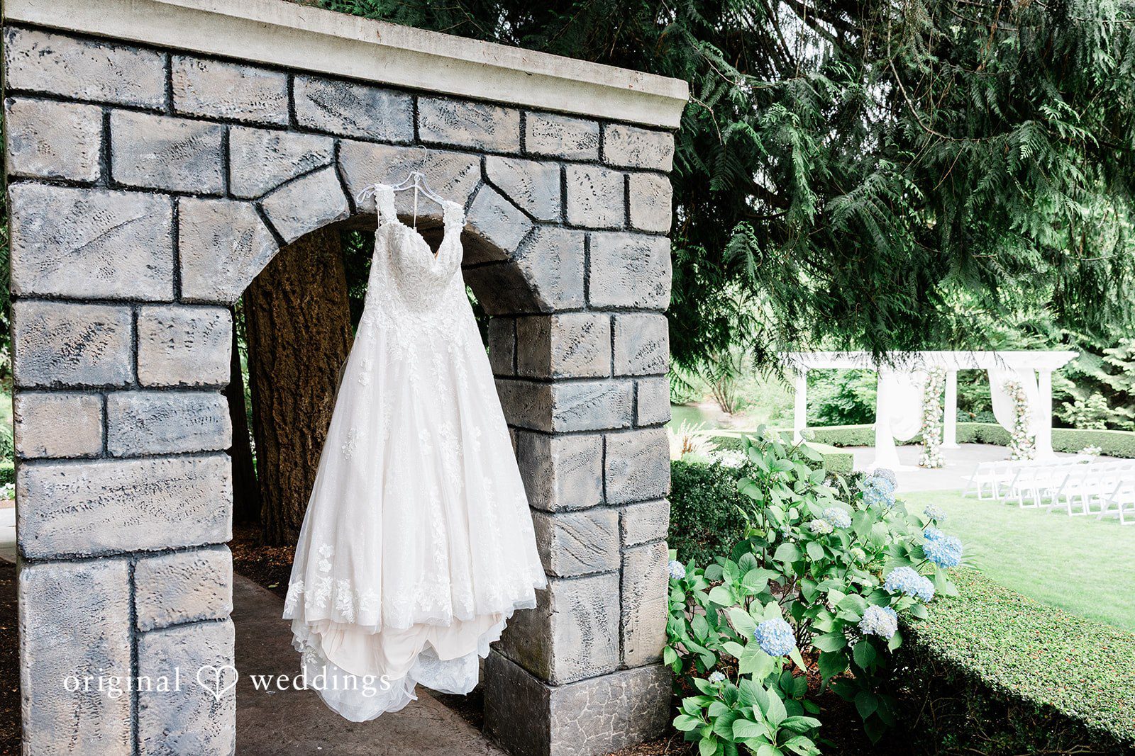 AlyssaMay + Benjamin Lovely bridal wedding dress hang across a wall