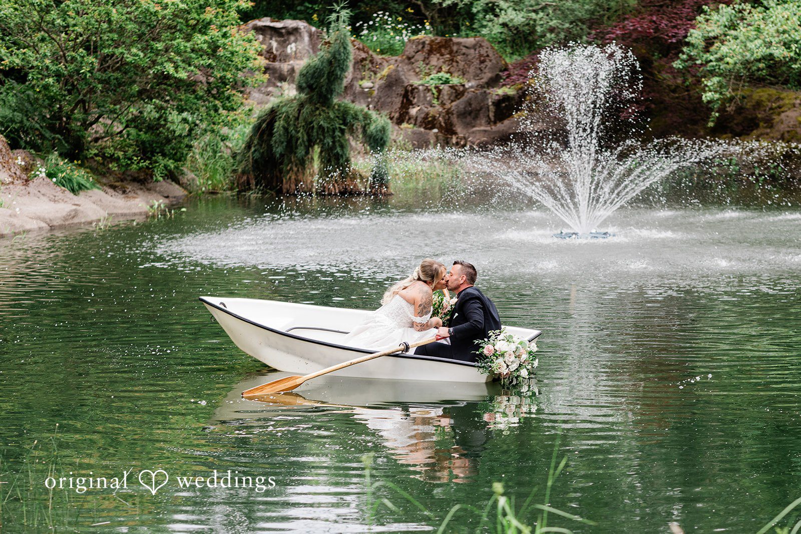 AlyssaMay + Benjamin Elegant picture of bride and groom in a boat sharing a kiss