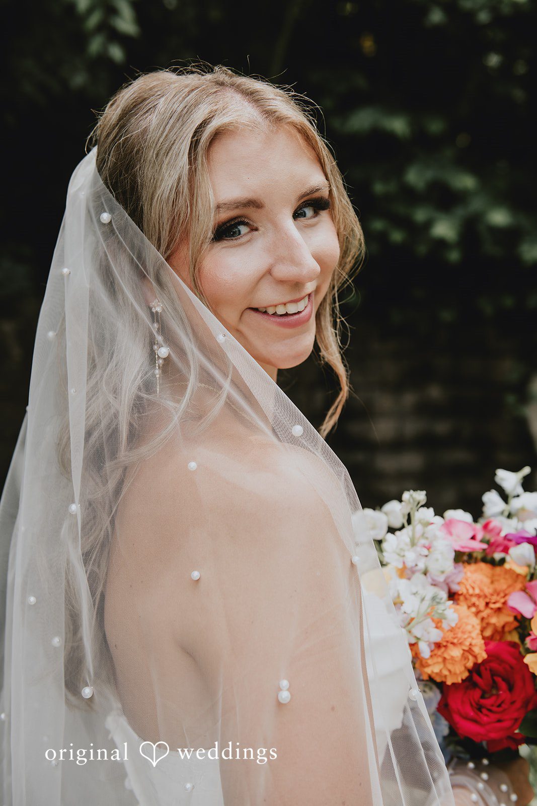 Julia + Kaleb Bride posing with her veil after wedding preparations
