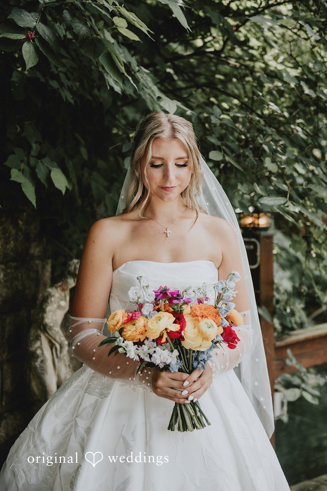 Julia + Kaleb Bride looking at her bouquet before the ceremony