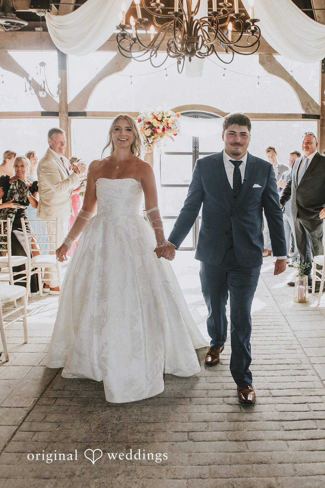Julia + Kaleb Newlyweds leaving the ceremony hand in hand