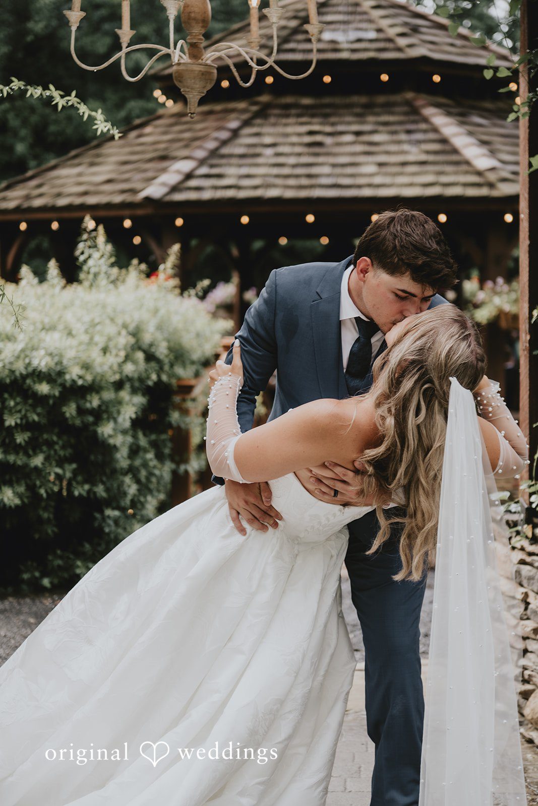 Julia + Kaleb Bride and groom kissing outside the venue