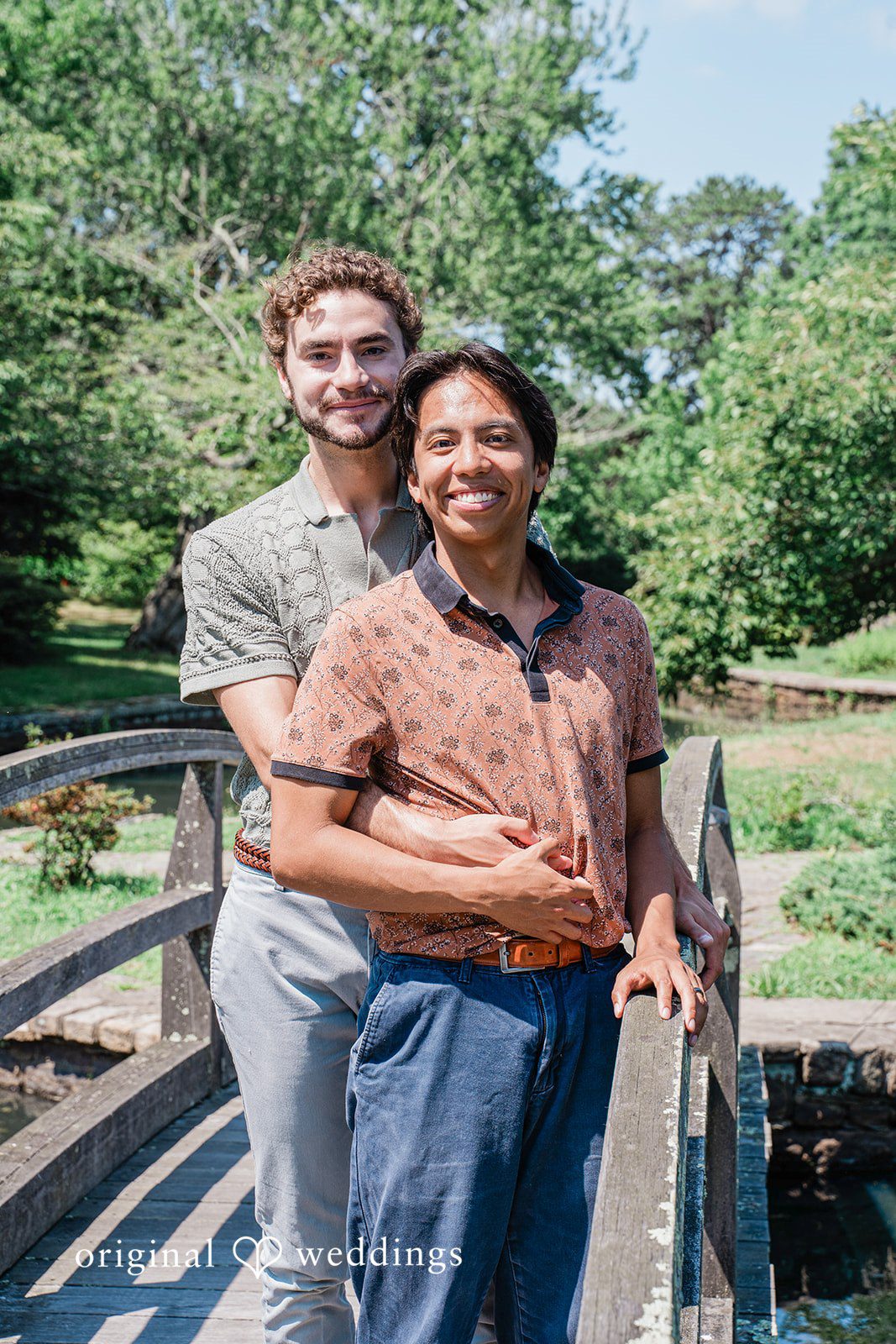 Engaged couple sharing a look while smiling at Roger Williams Park