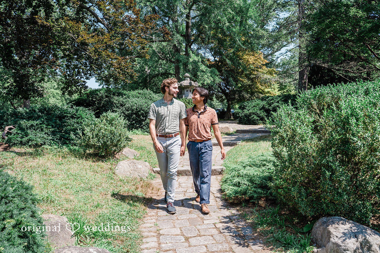 Engagement Photography Services by Original Weddings capturing couple walking and looking at each other at Roger Williams Park