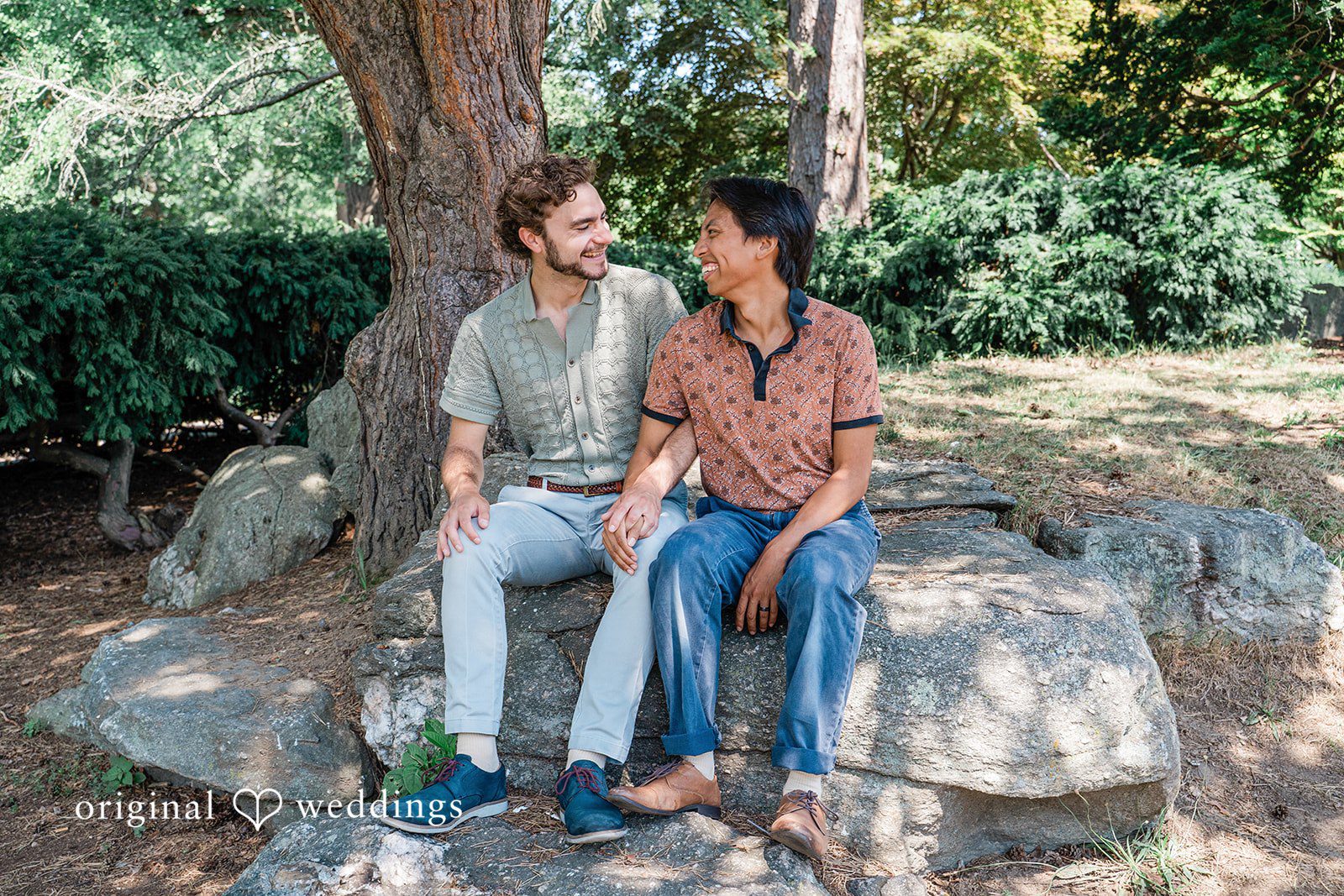 Couple sitting together near stone and looking each other at Roger Williams Park