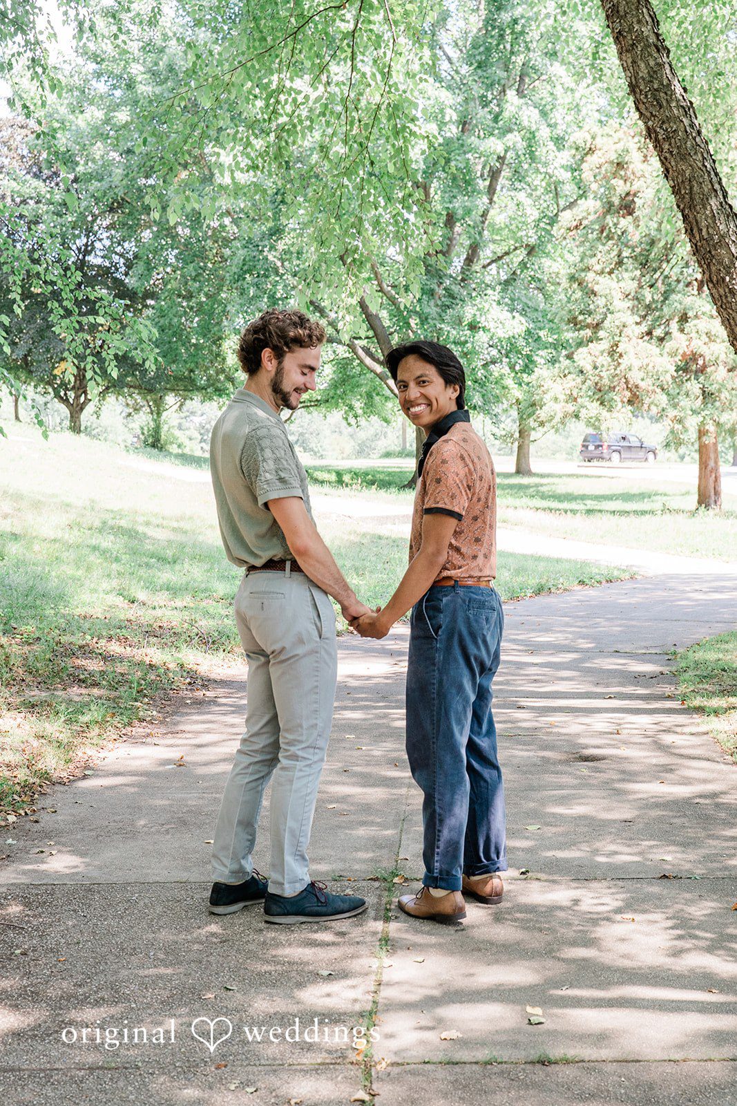 Couple smiling and holding hands at Roger Williams Park