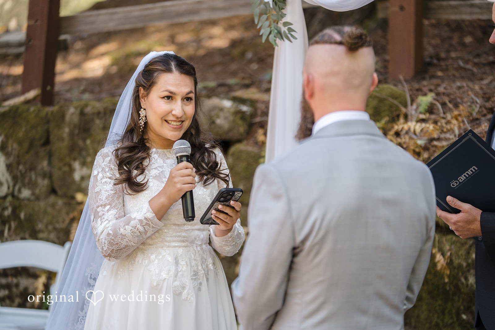 Brittany + Shane Bride holding a microphone while looking at the groom at Sanborn County Park