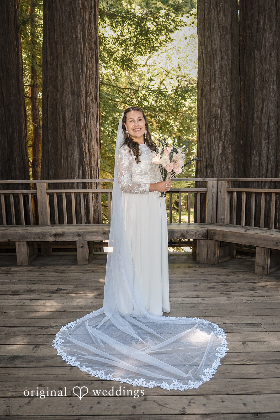 Brittany + Shane Bride smiling while holding a bouquet at Sanborn County Park