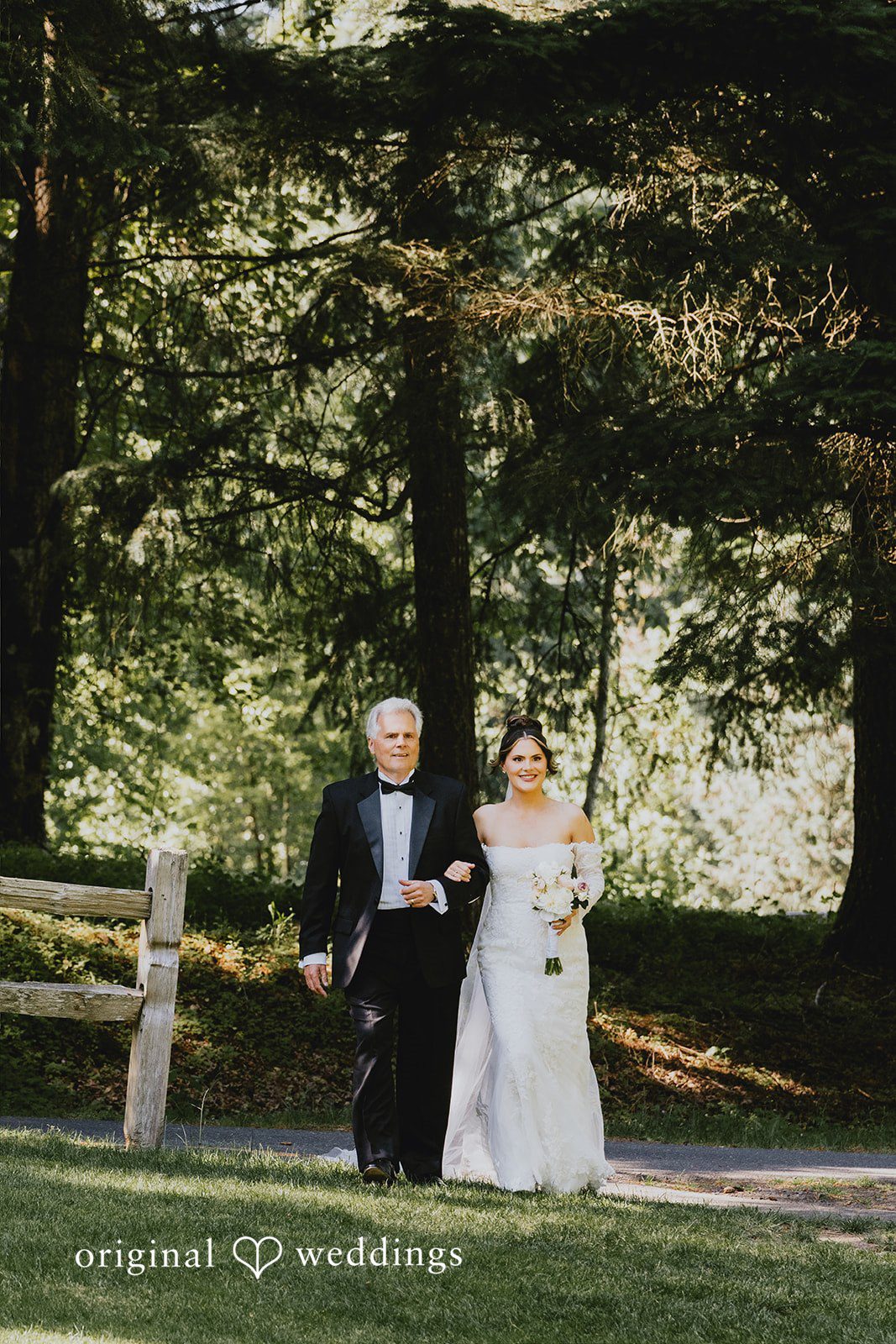 Kristina + Christopher Bride walking down a path arm-in-arm with a man.