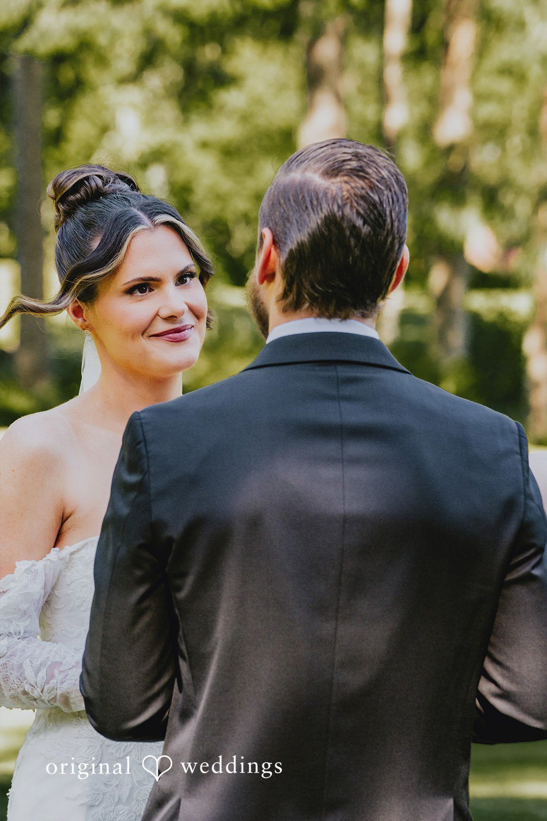Kristina + Christopher Bride looking lovingly at the groom from over his shoulder.
