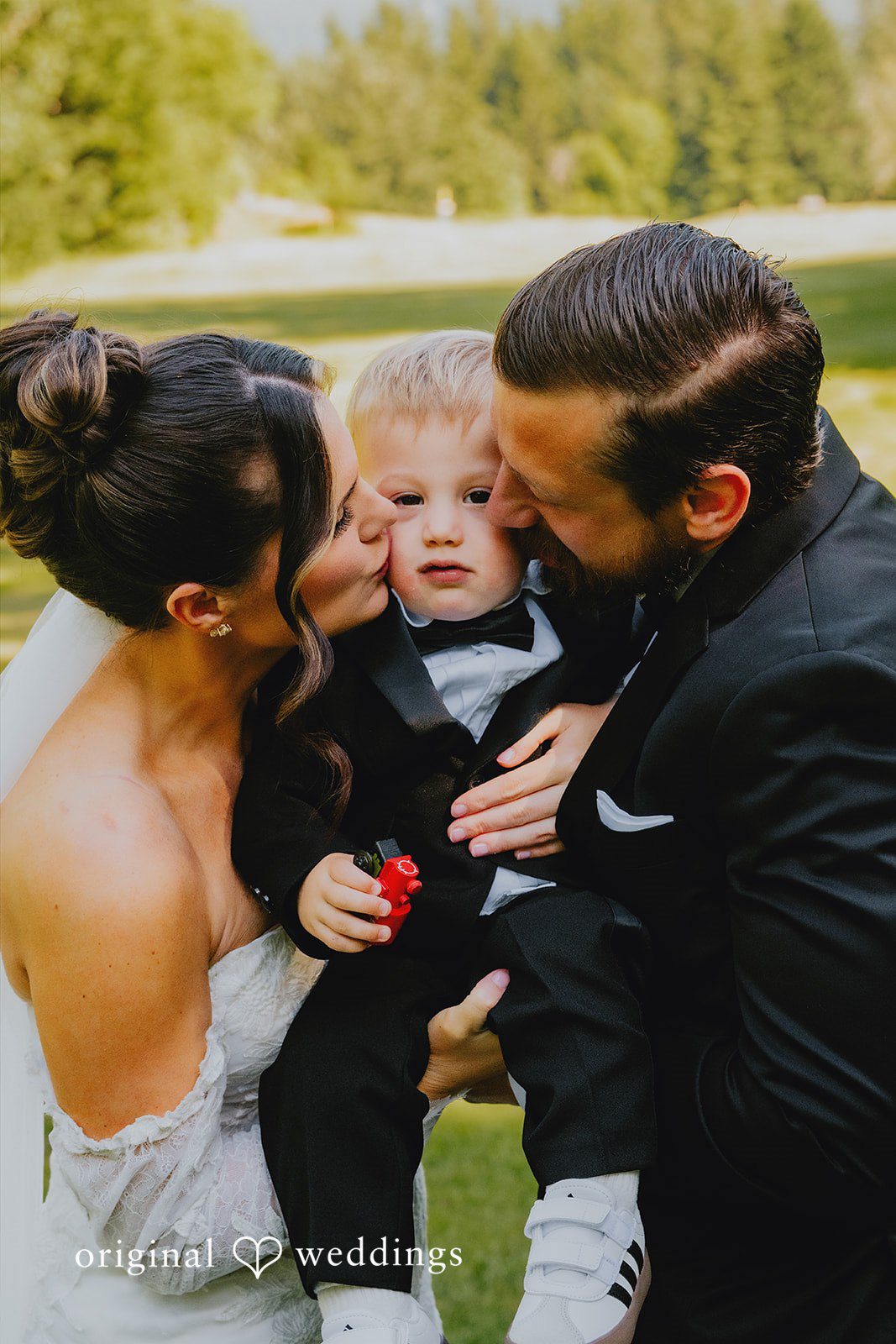 Kristina + Christopher A family portrait featuring the bride, groom, and a young child together.