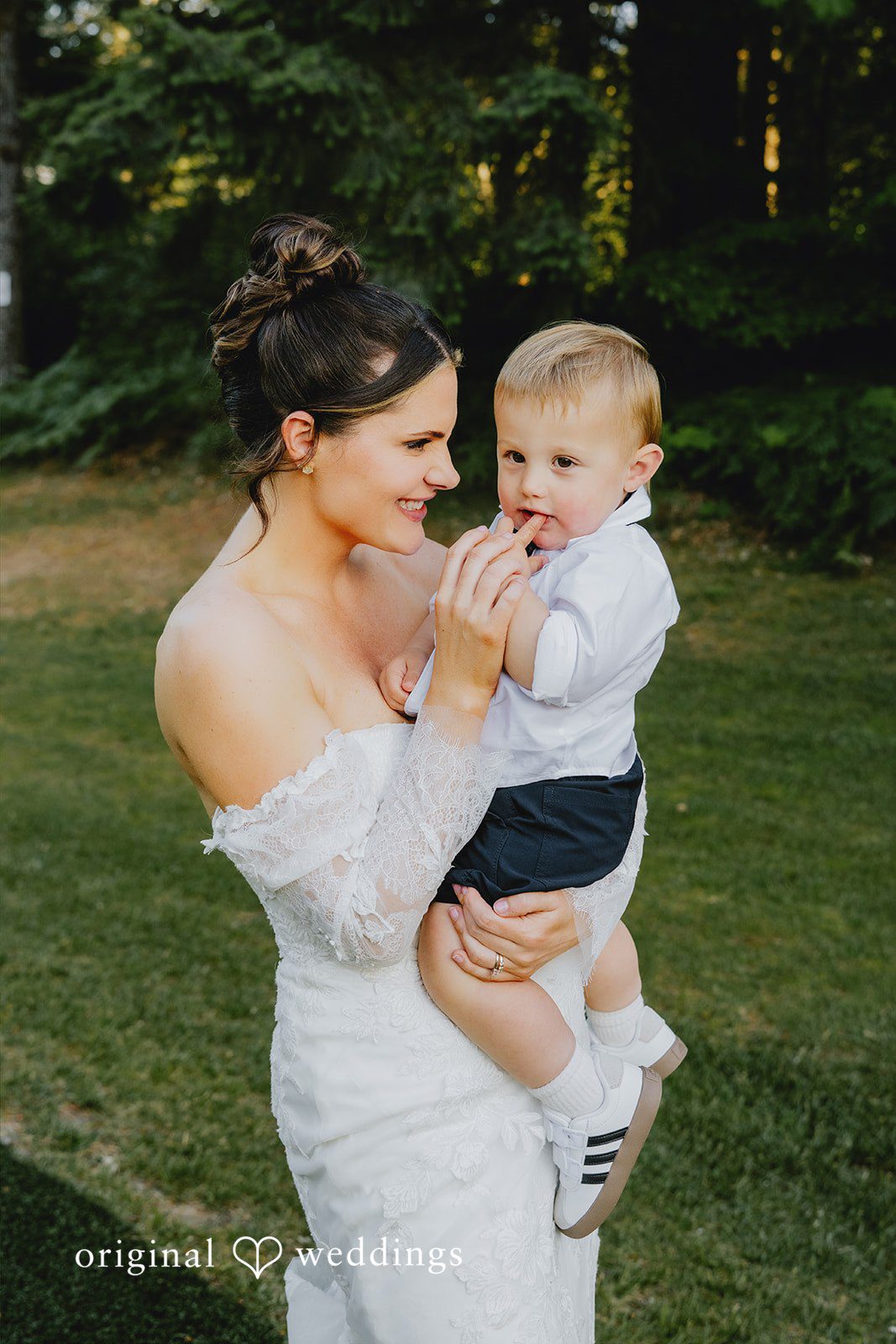 Kristina + Christopher A close-up portrait of a bride and a young child.