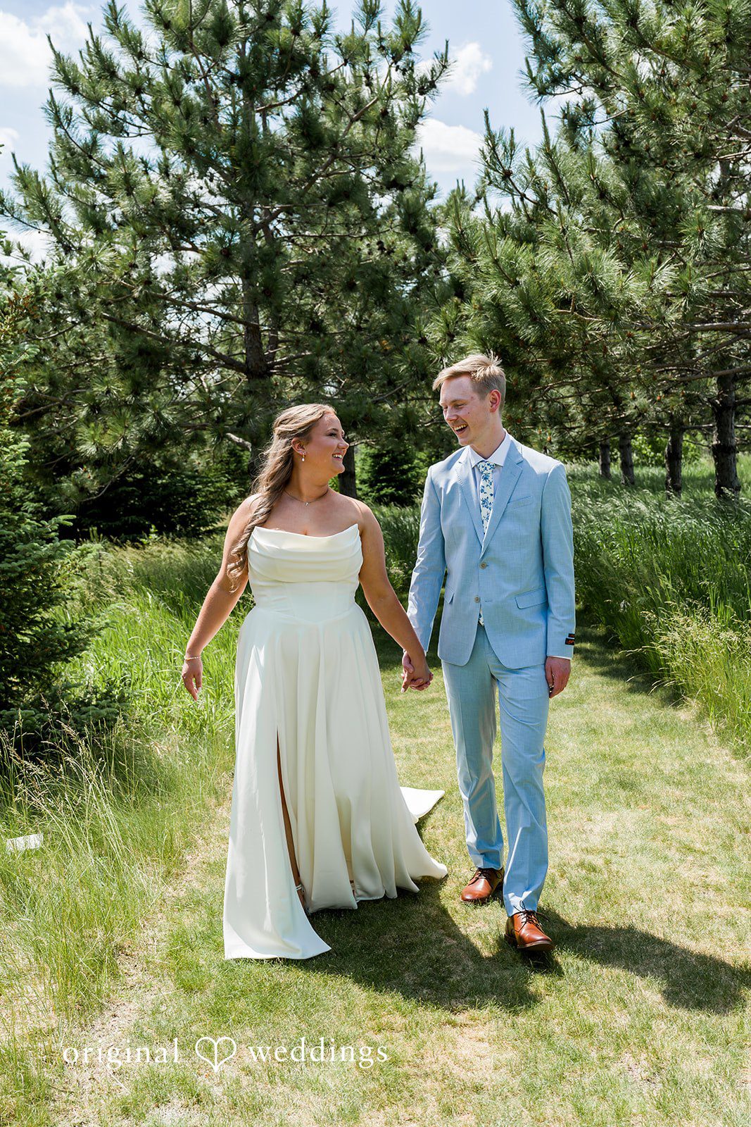 Emily + Ridge Bride and groom holding hands and walking together at Spruce Hill